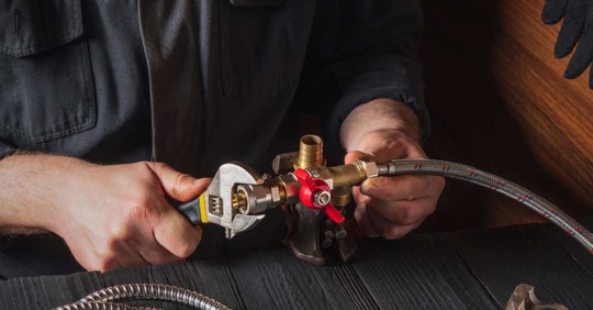 plumber working on faucet fittings
