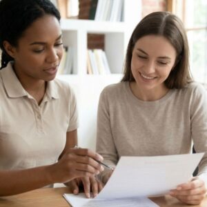 two people looking at a document