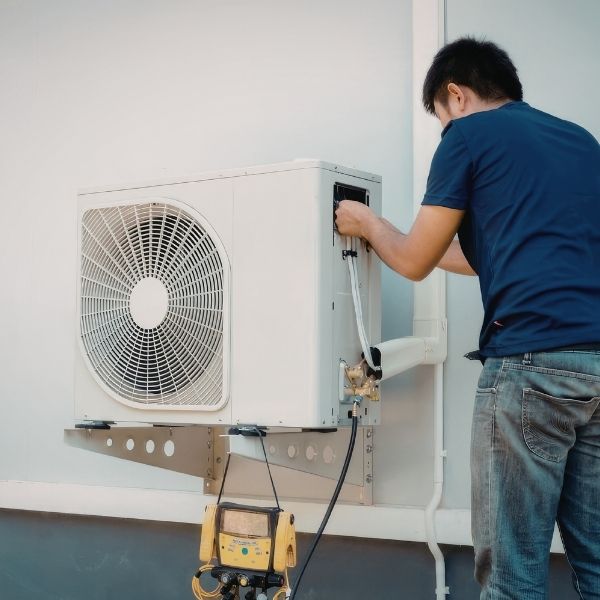 hvac technician working on hvac system